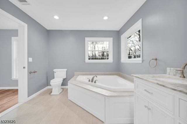 bathroom featuring a tub to relax in, tile patterned floors, vanity, and toilet