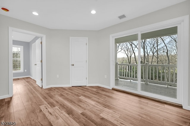 spare room featuring light hardwood / wood-style flooring