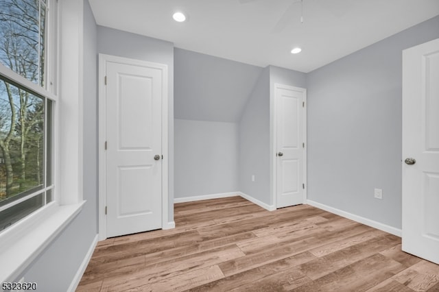 additional living space with ceiling fan and light hardwood / wood-style floors