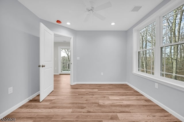 unfurnished room with ceiling fan and light hardwood / wood-style floors