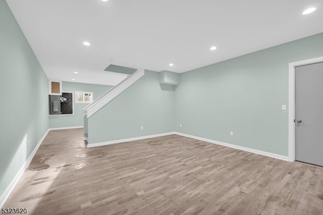 basement with light hardwood / wood-style floors