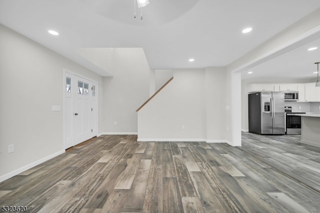 unfurnished living room with ceiling fan and hardwood / wood-style flooring