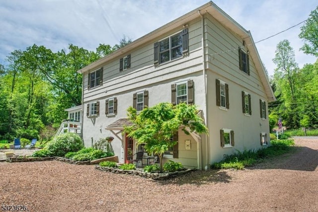 152 Fairmount Rd, Washington Twp, NJ 07853 - rear view of house with stucco siding and a patio