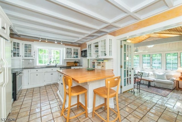 152 Fairmount Rd, Washington Twp, NJ 07853 - kitchen featuring stainless steel electric stove, open floor plan, wood counters, white cabinets, and beamed ceiling
