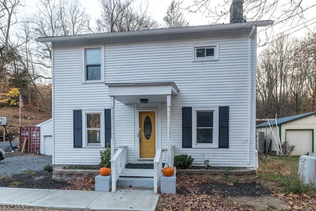 view of front of property featuring a garage and an outdoor structure