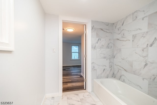 bathroom featuring wood-type flooring and a bathing tub