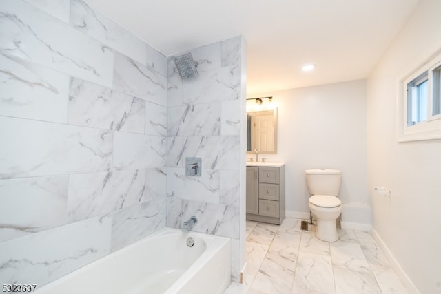 full bathroom featuring vanity, tiled shower / bath combo, and toilet