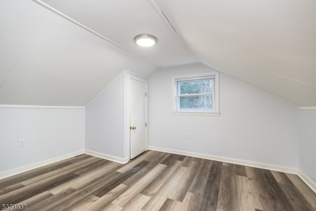 bonus room featuring dark wood-type flooring and lofted ceiling