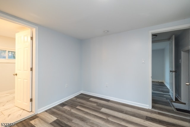 spare room with dark wood-type flooring