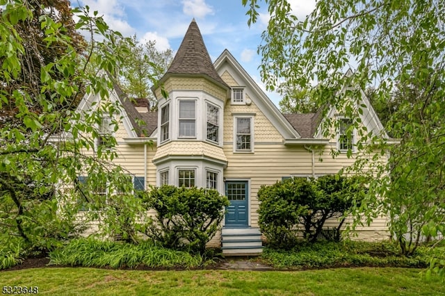 victorian house with a front yard