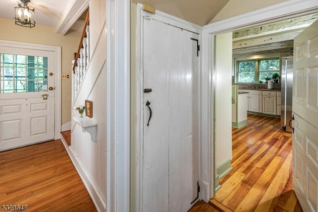 interior space with a notable chandelier, light hardwood / wood-style floors, and a healthy amount of sunlight