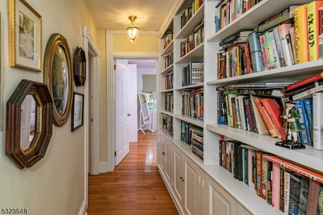 corridor with hardwood / wood-style flooring