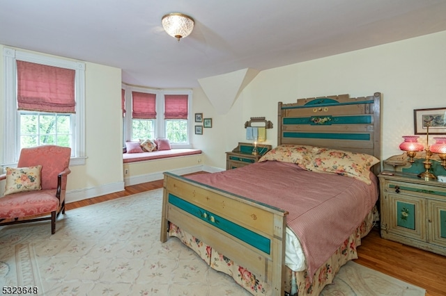 bedroom featuring light hardwood / wood-style floors and multiple windows