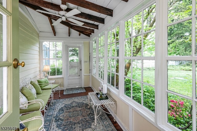 sunroom / solarium with lofted ceiling with beams, ceiling fan, and a wealth of natural light