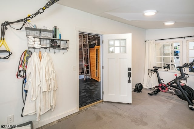 workout room with concrete floors and vaulted ceiling