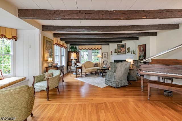 interior space with hardwood / wood-style flooring, plenty of natural light, and beamed ceiling