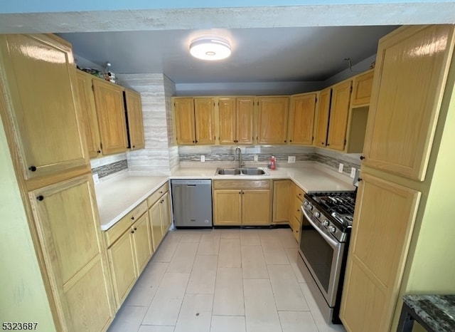 kitchen with light brown cabinets, sink, decorative backsplash, and appliances with stainless steel finishes