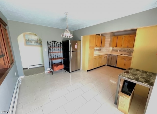 kitchen featuring a baseboard radiator, hanging light fixtures, sink, and stainless steel appliances