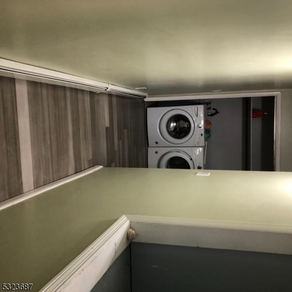 clothes washing area with stacked washer / drying machine