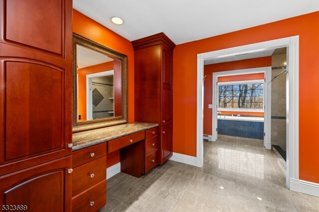 bathroom with vanity and shower with separate bathtub