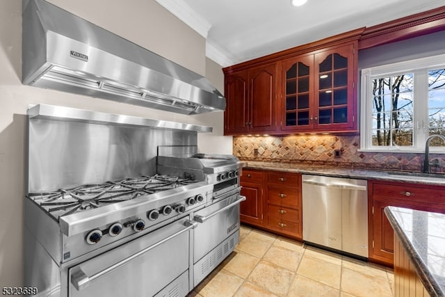 kitchen featuring dark stone counters, sink, decorative backsplash, stainless steel dishwasher, and wall chimney exhaust hood