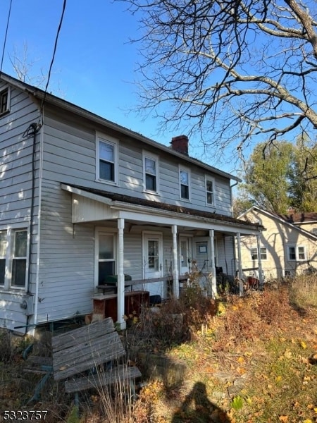 back of property with covered porch