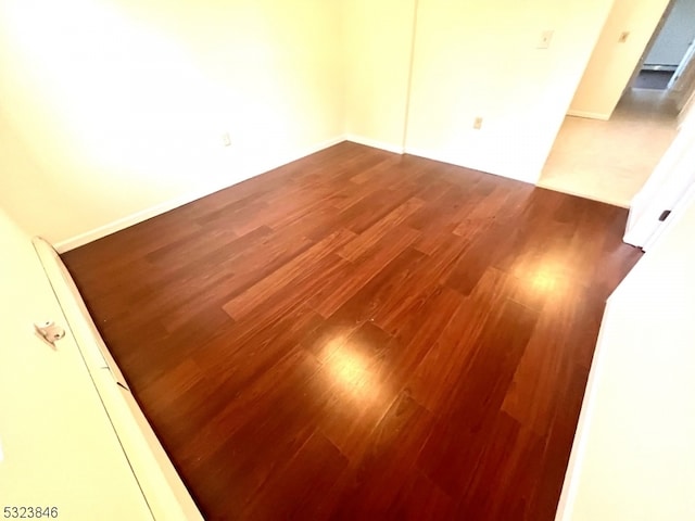 spare room featuring dark hardwood / wood-style flooring