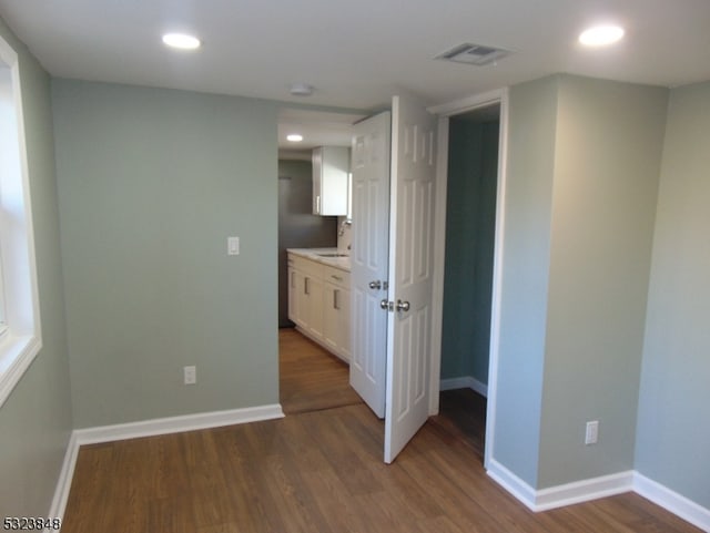 unfurnished room with dark hardwood / wood-style flooring