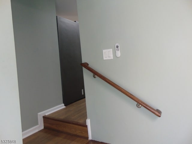 staircase with wood-type flooring