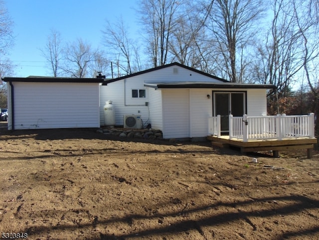 back of property featuring a wooden deck