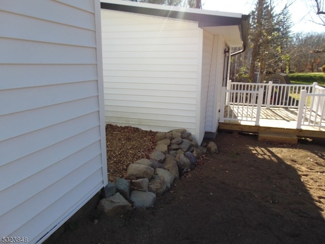 view of side of home with a wooden deck