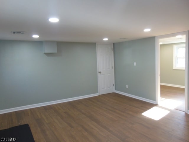 basement featuring dark hardwood / wood-style flooring