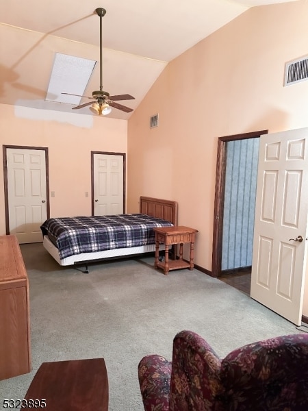 carpeted bedroom with vaulted ceiling and ceiling fan