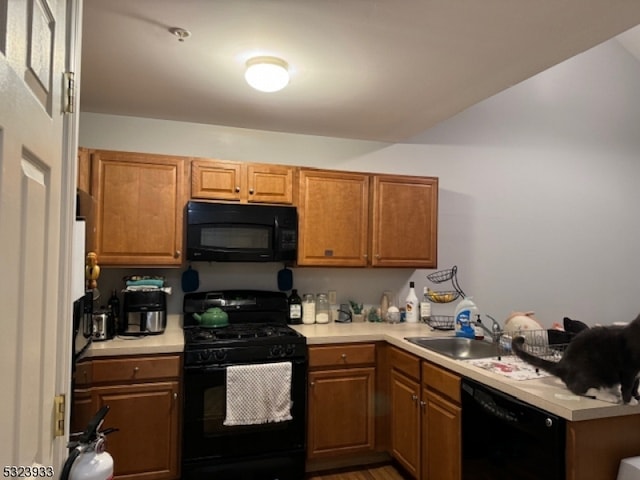 kitchen featuring black appliances and sink