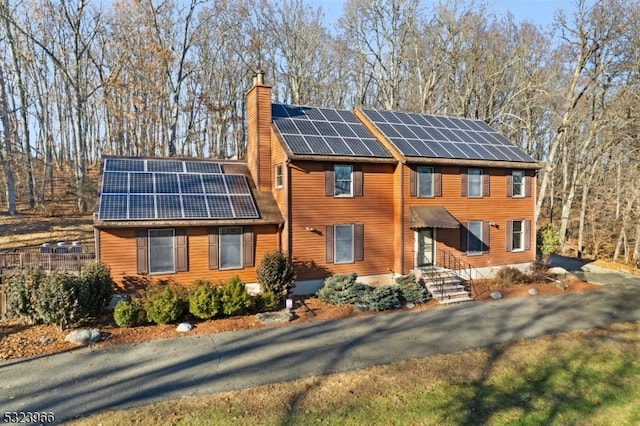 view of front of property featuring solar panels