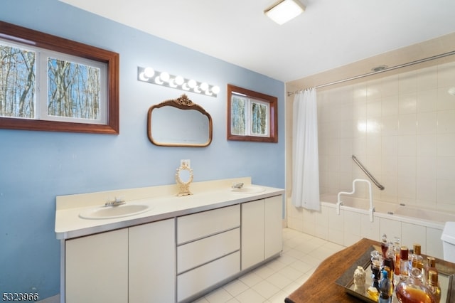 bathroom with shower / bath combo, vanity, and tile patterned floors