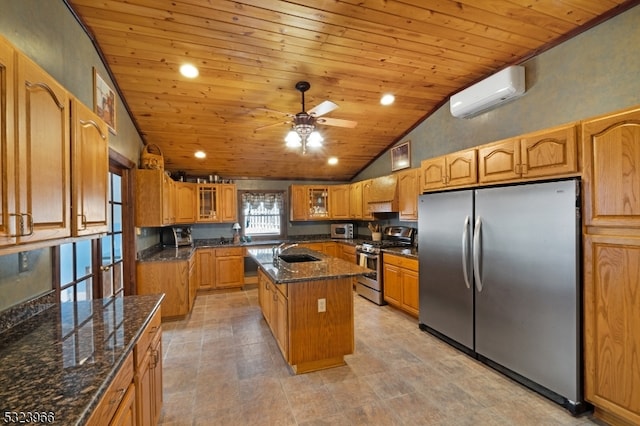 kitchen featuring stainless steel appliances, a wall unit AC, sink, a center island with sink, and wooden ceiling