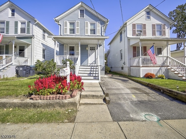 view of front facade with a front yard and a porch