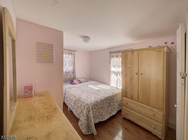 bedroom with wood-type flooring