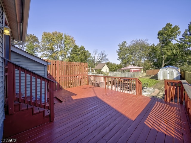 wooden terrace with a storage shed