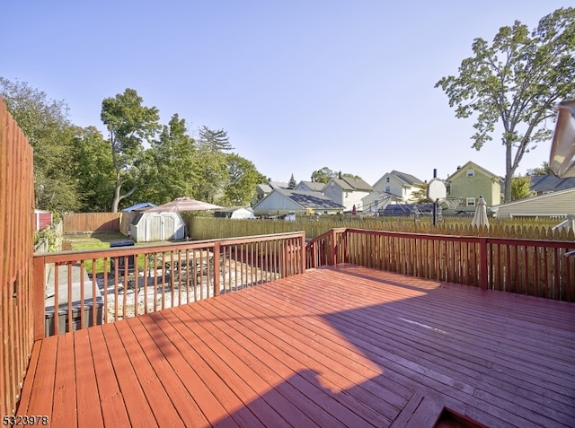 wooden terrace with a storage shed