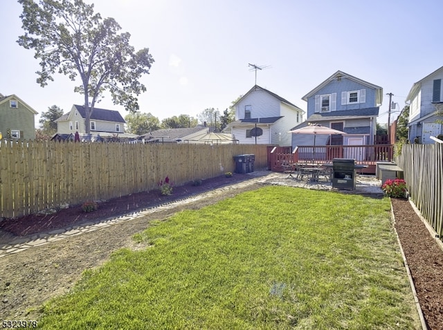 view of yard featuring a wooden deck and a patio area