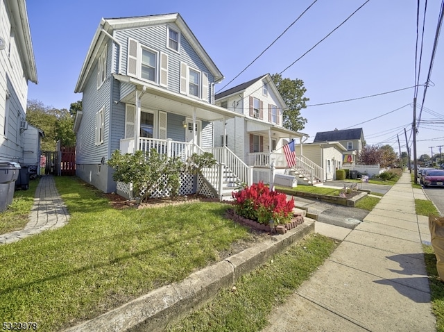 view of front of house with a front yard and covered porch