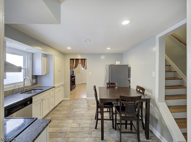 dining room with light hardwood / wood-style flooring and sink