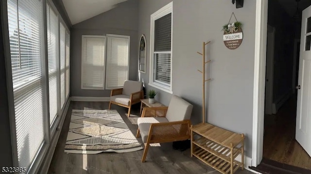 sunroom / solarium featuring vaulted ceiling