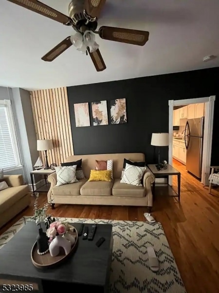 living room featuring hardwood / wood-style floors and ceiling fan