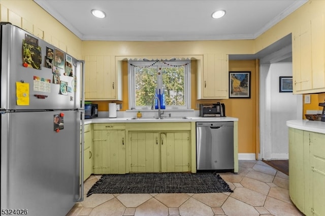 kitchen with light tile patterned floors, crown molding, sink, and appliances with stainless steel finishes