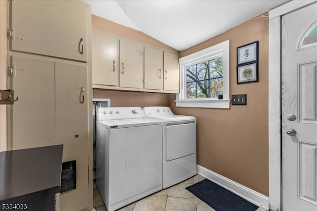 laundry area with cabinets, independent washer and dryer, and light tile patterned floors