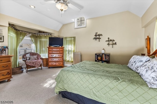 carpeted bedroom with radiator heating unit, vaulted ceiling, and ceiling fan