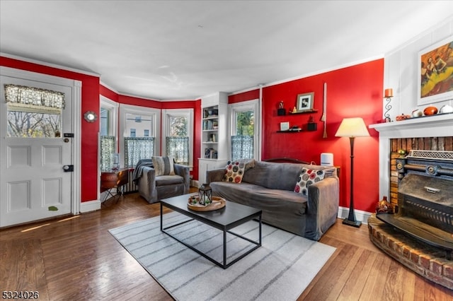 living room featuring hardwood / wood-style flooring and crown molding